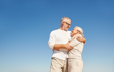 Image showing happy senior couple talking outdoors