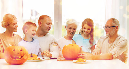 Image showing happy family sitting with pumpkins at home