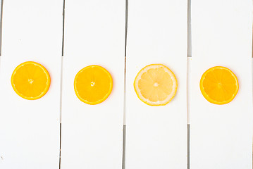 Image showing Colorful citrus fruits on the rustic white background.