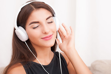 Image showing Woman listening music in headphones