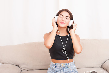 Image showing Woman listening music in headphones