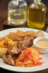 Image showing Grilled pork, baked potatoes and vegetable