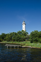 Image showing Lighthouse and an old wooden pier