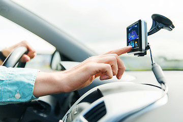 Image showing close up of man with gps navigator driving car