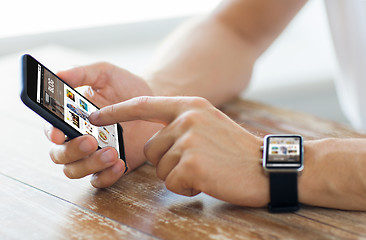 Image showing close up of hands with smart phone and watch