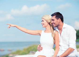 Image showing couple sitting at sea side