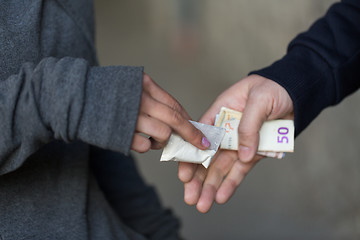 Image showing close up of addict buying dose from drug dealer