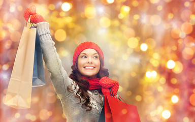 Image showing happy woman in winter clothes with shopping bags