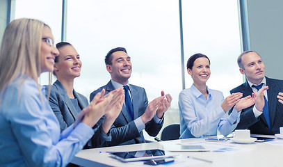 Image showing business team with laptop clapping hands