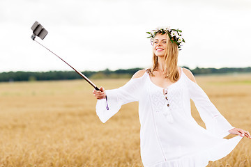 Image showing happy young woman taking selfie by smartphone