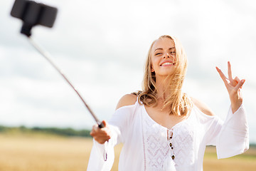 Image showing happy young woman taking selfie by smartphone