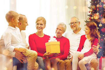 Image showing smiling family with gifts at home