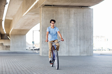 Image showing young hipster man riding fixed gear bike