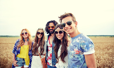 Image showing smiling young hippie friends on cereal field