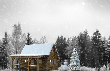 Image showing Snowman in the woods near the festive Christmas tree.