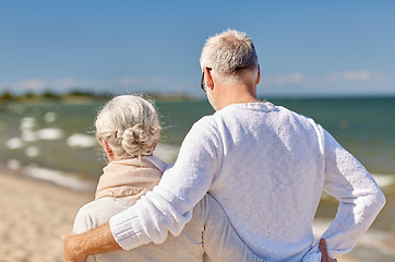 Image showing happy senior couple hugging on summer beach