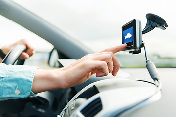 Image showing close up of man with gadget on screen driving car