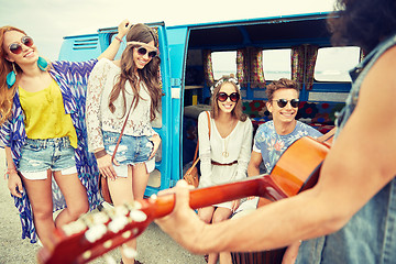 Image showing happy hippie friends playing music over minivan