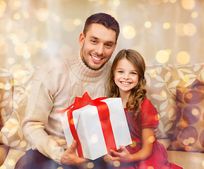 Image showing smiling father and daughter holding gift box