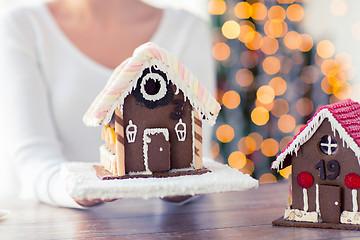 Image showing close up of woman showing gingerbread house