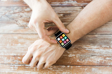 Image showing close up of hands setting smart watch with icons