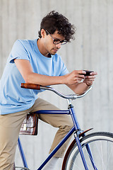 Image showing man with smartphone and fixed gear bike on street