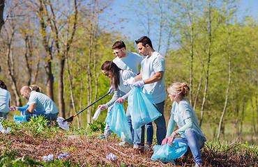 Image showing volunteers with garbage bags cleaning park area