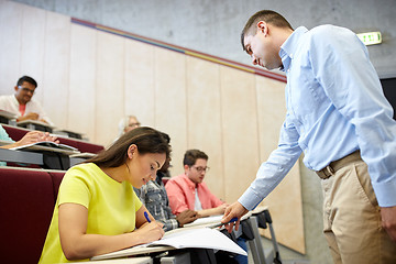 Image showing group of students and teacher with notebook