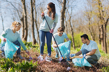 Image showing volunteers with garbage bags cleaning park area