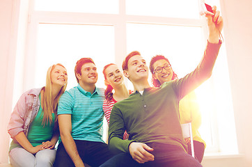 Image showing five smiling students taking picture with camera