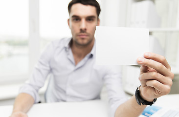 Image showing close up of businessman with blank paper at office