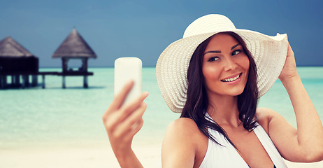 Image showing young woman taking selfie with smartphone