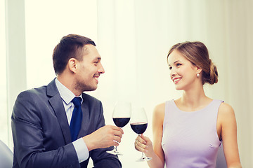 Image showing young couple with glasses of wine at restaurant