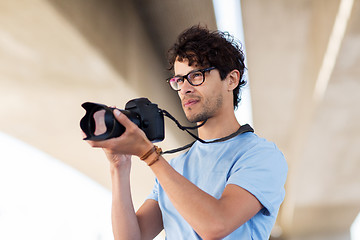 Image showing photographer with digital camera shooting in city