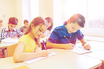 Image showing group of school kids writing test in classroom