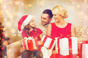 Image showing smiling family holding many gift boxes