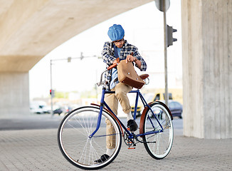 Image showing hipster man with shoulder bag on fixed gear bike
