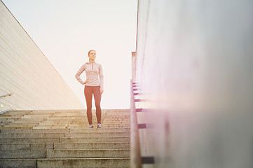 Image showing sporty woman standing on in city stairs
