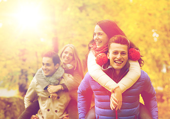 Image showing smiling friends having fun in autumn park