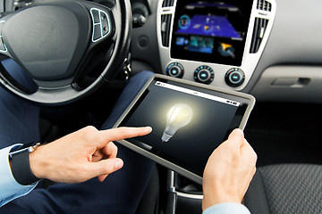 Image showing close up of man with tablet pc in car