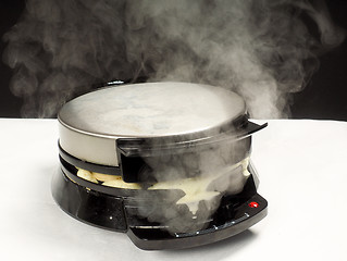 Image showing Making of fresh steaming hot waffles