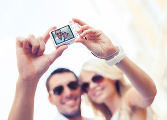 Image showing travelling couple taking photo picture with camera