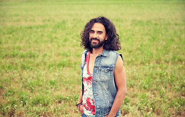 Image showing smiling young hippie man on green field