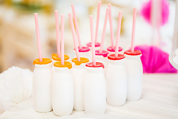 Image showing close up of bottles with drinks and straws