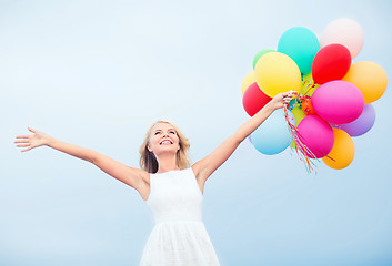 Image showing woman with colorful balloons outside