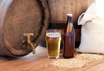 Image showing close up of beer barrel, glass, bottle and malt