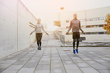 Image showing man and woman exercising with jump-rope outdoors