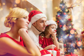 Image showing depressed family at home with many gift boxes