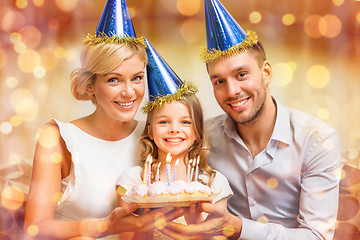 Image showing smiling family in blue hats with cake