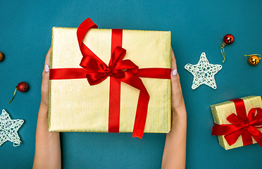 Image showing Hands of woman and Christmas gift box.